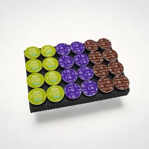 May include: A black rectangular storage tray holding twenty-four Nescafé Dolce Gusto coffee capsules. The capsules are arranged in four rows of six, featuring green Cappuccino, purple Mocha, and brown Chococino varieties with visible text.