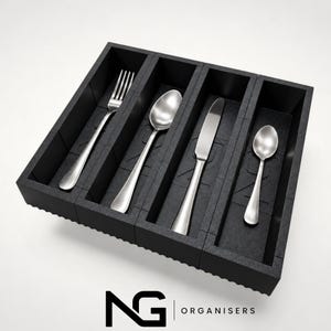 May include: A black rectangular cutlery organizer with four vertical compartments. Inside the slots are a silver fork, a large silver spoon, a silver dinner knife, and a small silver teaspoon. The logo NG ORGANISERS is printed below the tray.