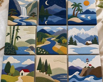 May include: A set of nine square fabric tiles featuring embroidered landscape scenes, including a waterfall, a night mountain view, a tropical beach, bamboo, a river valley, snowy mountains, a house, pine trees, and a lighthouse by the sea.