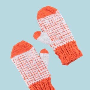 May include: A pair of knitted mittens with a white and orange chevron pattern. The cuffs and tips of the mittens are solid orange. The word "PATTERN" is in a white rectangle at the top of the image.