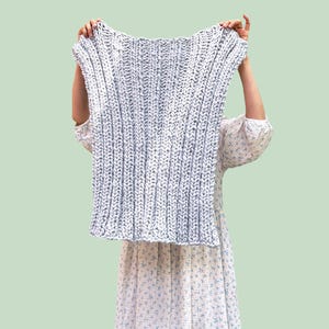 May include: A light blue chunky knit rectangular piece with a vertical ribbed texture. The image features the text DIY KIT in a pink box at the top and the word BEGINNER in blue text at the bottom, indicating a craft project for novices.