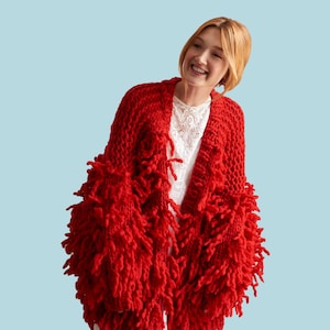 May include: A red knitted cardigan with a fringe detail. The cardigan is open at the front and has long sleeves.