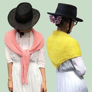 May include: A DIY KIT for a beginner featuring two knitted triangular shawls. One shawl is light pink and tied in the front, while the other is bright yellow and worn over the shoulders. Both are paired with black hats and white dresses.