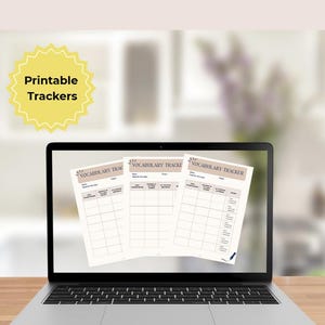 May include: A laptop screen displays three sheets of Vocabulary Tracker printables. Each sheet features fields for date, goal, topic, and a table with columns for new vocabulary, meaning in own words, and my example sentence. A yellow starburst icon says Printable Trackers.