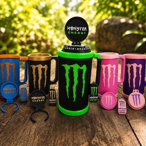 May include: A collection of Monster Energy branded drink mugs and accessories in various colors including white, blue, black, green, pink, purple, and yellow. Each item features the iconic Monster Energy claw logo and text.