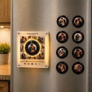May include: A square acrylic plaque featuring a collage of couple photos, a central circular vinyl record graphic with a glowing light, and music player controls with the text Better Together. Eight circular photo magnets are arranged nearby.