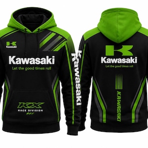 Könnte beinhalten: Ein schwarzer und lindgrüner Kapuzenpullover mit dem Kawasaki-Logo und dem Schriftzug Let the good times roll auf der Vorder- und Rückseite. Die Vorderseite zeigt das KX Race Division Branding, während beide Ärmel den Namen Kawasaki in Weiß tragen.