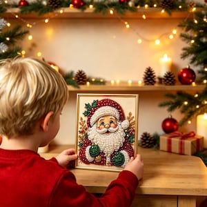May include: A rectangular framed art piece featuring a Santa Claus portrait crafted from small, round, pearl-like beads in shades of red, white, and green. The Santa figure has a white beard, a red hat, and green mittens, accented with gold details.