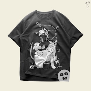 May include: A charcoal gray short-sleeve t-shirt featuring a white line-art graphic of various cartoon characters, including a human, a dog, and a crown-wearing figure. The design includes small butterfly motifs and a skull, with the letters DG M.