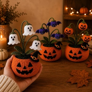 May include: Three crocheted Halloween-themed potted plants. One pot features white ghost flowers, another has purple bat flowers, and the third has orange jack-o'-lantern flowers. Each orange pot has a jack-o'-lantern face and a small black witch hat.