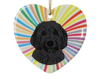 May include: A black doodle dog with a rainbow background on a heart-shaped ceramic ornament.