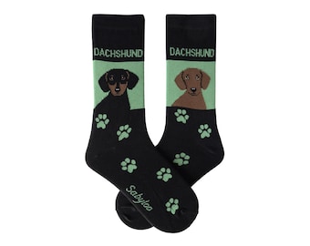 May include: A pair of black socks with a green dachshund print. The socks have the word "Dachshund" written on them and green paw prints.