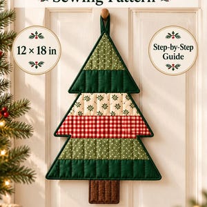 May include: A Mini Tree Quilt Sewing Pattern digital download featuring a 12 x 18 in finished size and step-by-step guide. The image shows a quilted Christmas tree wall hanging with horizontal bands of green, cream, red plaid, and brown.