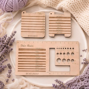 May include: Three light-coloured wooden fibre tools for measuring yarn. Two square tools feature horizontal slots labelled with yarn weights and wraps per inch. A large rectangular Fibre Ruler includes slots for yarn weights and circular holes for needle sizing.