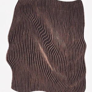 May include: A rectangular rug with irregular, wavy edges featuring a dark brown background and a pattern of thin, light peach-colored vertical lines that curve and distort across the surface to create a sense of depth and movement.