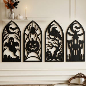 May include: Four black arched wall panels featuring intricate laser-cut designs. The panels depict a ghost with a crescent moon, a spider above a jack-o'-lantern, a raven perched on a tree with tombstones, and a castle silhouette with bats.