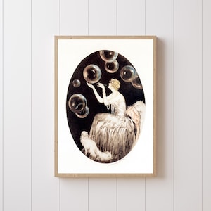 May include: A framed art print featuring an oval illustration of a figure in a long gown blowing bubbles. The scene is set against a dark background with a small white dog sitting at the base of the figure, all enclosed in a light wood frame.