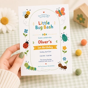May include: A white rectangular birthday invitation card featuring colorful illustrations of a bee, butterfly, ladybug, caterpillar, and ant. The text reads Little Bug Bash, Our little bug is turning one, Oliver's 1st Birthday, Sunday, April 21st, 3:00 PM - 5:00 PM, The Sunny Garden, 45 Blossom Lane, Austin, TX, and RSVP to Emma at 555.218.9046.