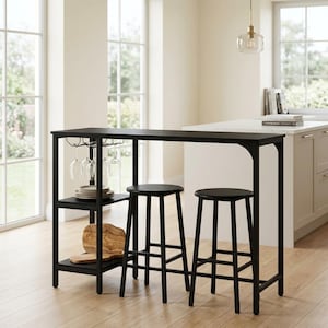 May include: A black rectangular bar table with a built-in side shelving unit, a stemware rack holding four clear wine glasses, and two matching black round stools. The shelves contain a stack of white plates and a wooden cutting board.