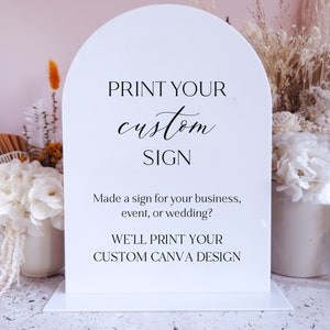 May include: White acrylic sign with a rounded top, featuring the text "PRINT YOUR custom SIGN" and "Made a sign for your business, event, or wedding? WE'LL PRINT YOUR CUSTOM CANVA DESIGN".