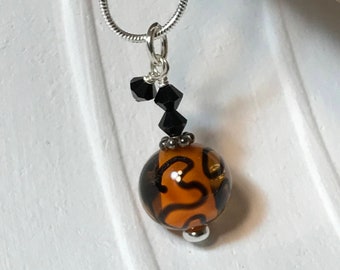 Delicate orange glass necklace with black crystals