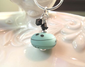 Necklaces teal green Lampwork glass bead with black and white details, crystals, Alaska