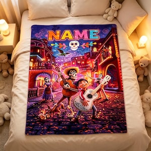 May include: A rectangular fleece blanket featuring a vibrant, colourful scene inspired by the movie Coco, with the text NAME at the top. The design includes characters playing guitars, a skull, and a cobblestone street at night with warm lighting.