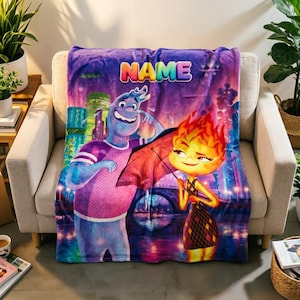 May include: A plush throw blanket featuring a colorful graphic print of two animated characters, one blue and one orange, standing under an umbrella. The word NAME is printed in large, multi-colored letters at the top against a purple city background.