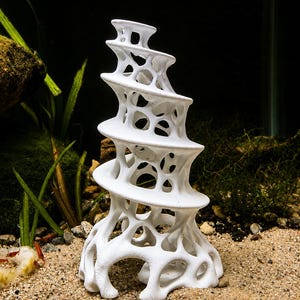 May include: A white, spiraling, tower-like aquarium ornament featuring an intricate, organic, lattice-style structure with multiple open voids and a wide, stable base, designed with a continuous, winding, shelf-like form that tapers toward the top.