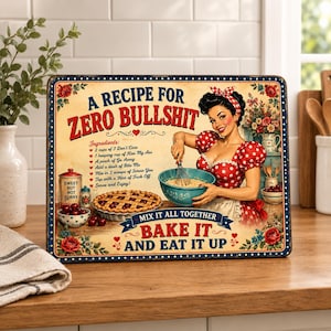 May include: A rectangular metal sign featuring a vintage-style illustration of a person in a red polka-dot dress mixing ingredients in a blue bowl. The text reads A RECIPE FOR ZERO BULLSHIT, followed by a list of ingredients and BAKE IT AND EAT IT UP.