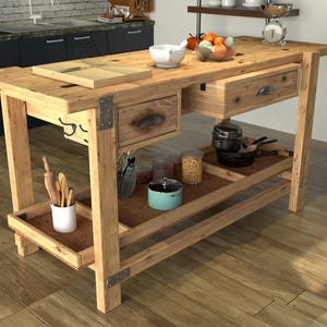 May include: A rectangular wooden kitchen island featuring a light brown natural wood grain finish, two drawers with metal pulls, and a lower shelf. The top surface holds a white bowl, a cutting board, and fruit, while the shelf stores various kitchen items.