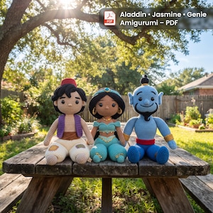 May include: Three amigurumi dolls representing Aladdin, Jasmine, and the Genie. Aladdin wears a purple vest and cream pants with patches. Jasmine wears a teal outfit with gold accents. The Genie is blue with a red waistband and gold cuffs.