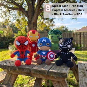 May include: Five crocheted dolls representing Spider-Man, Iron Man, Captain America, Hulk, and Black Panther. The dolls feature yarn textures and character-specific colors. A PDF label displays the text: Spider-Man • Iron Man • Captain America • Hulk • Black Panther – PDF.