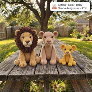 May include: Three crocheted lion figures including a large male lion with a dark brown mane, a medium-sized lioness in light tan, and a small lion cub in golden yellow. Each figure features embroidered facial details and dark eyes.