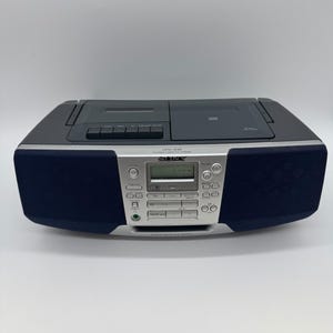 May include: A black and silver Sony CFD-S36 portable CD radio cassette recorder. The device features a central digital display, control buttons, a top-loading CD compartment, a cassette deck, and integrated speakers on the left and right sides.