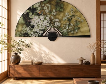 May include: A large, semi-circular wall-mounted folding fan featuring a detailed illustration of white cherry blossoms, dark branches, and small birds against a golden background, with a black frame and a central black pivot point.