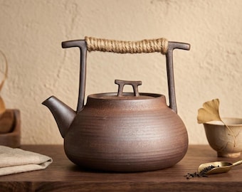 Tetera japonesa de cerámica rústica hecha a mano, hervidor de gres rústico con asa de cuerda de yute.