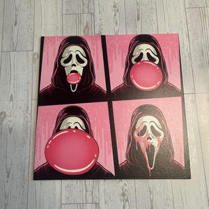 May include: A square canvas print featuring four panels of the Ghostface character from the Scream horror franchise. The character wears a black hooded robe and white mask, blowing a large pink bubblegum bubble that eventually pops and drips.