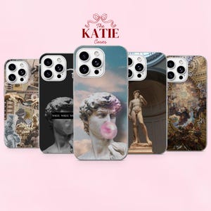 May include: Five smartphone cases featuring classical art motifs, including a statue blowing a pink bubble, a full-body statue in an architectural setting, and intricate Renaissance-style paintings. The brand name The KATIE Cases is at the top.