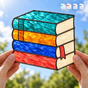 May include: A stained glass suncatcher featuring a stack of four books with textured covers in teal, orange, blue, and red. The book spines are outlined in dark metal, and a small red bookmark hangs from the side of the blue book.