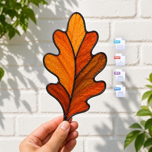 May include: A stained glass oak leaf ornament featuring textured orange and amber glass segments outlined in black metal cames. To the right, four stacked file icons are labeled SVG, PDF, JPG, and PNG, indicating available digital file formats.