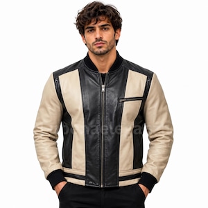 Puede incluir: Una chaqueta tipo bomber con bloques de color que presenta un panel central de cuero negro, paneles laterales en color beige y mangas de cuero negro. La chaqueta incluye un cuello acanalado negro, puños acanalados negros, cremallera y bolsillo.