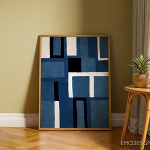 May include: Abstract art print with a geometric design in shades of blue and white. The print is framed in a natural wood frame.