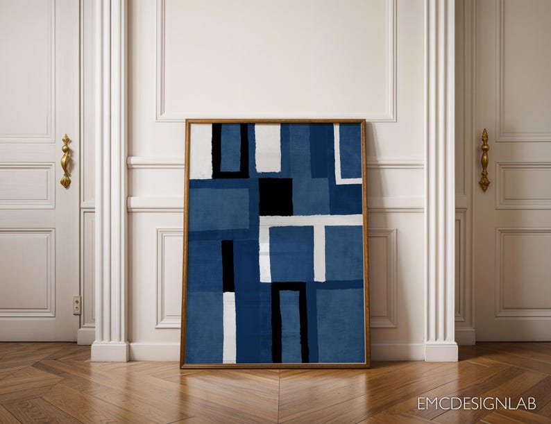 May include: Abstract geometric art print in shades of blue with white and black accents. The print is framed in a simple wooden frame.