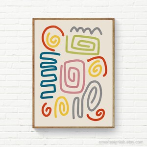 May include: Abstract art print with a beige background and colorful shapes. The shapes are in shades of red, orange, yellow, green, blue, and pink. The print is framed in a light brown frame.