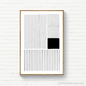 May include: Abstract black and white art print in a wooden frame. The artwork features vertical and horizontal lines, a solid black square, and a rectangular shape. The print is displayed against a white brick wall.