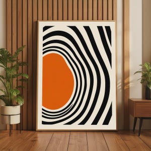 May include: A rectangular framed wall art print featuring a large, solid orange organic shape positioned on the left side, surrounded by concentric black and off-white wavy lines that create a sense of depth and movement across the entire surface.