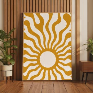 May include: A rectangular wall art print featuring a mustard yellow and white sunburst pattern with wavy, radiating lines extending from a central white circle. The artwork is encased in a thin, light-toned wooden frame, displaying a bold graphic design.
