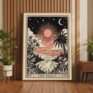 May include: A rectangular wall art print titled THE WORLD featuring a stylized illustration of a sun, crescent moon, stars, clouds, a palm tree, and floral elements over a landscape. The artwork uses a palette of black, cream, and peach tones.