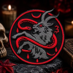 May include: A circular embroidered patch featuring a grey goat head and body with a red snake coiled around it. The design includes a red crescent moon, red blood drops, and the number 3 in red on a black background with a red border.